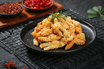 Crispy Fried Chicken Strips with Rosemary Garnish and Spice Display