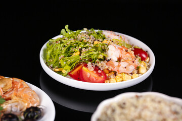 Healthy Quinoa Shrimp Bowl with Mixed Greens and Cherry Tomatoes on Dark Background