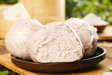 Artisan Whole Wheat Bread Buns with Rustic Texture on Wooden Plate