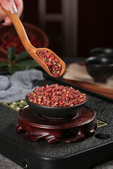 Red Sichuan Peppercorns in Wooden Spoon and Bowl - Chinese Spice Granules for Traditional Asian Cooking