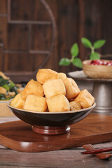 Delicious Deep-Fried Tofu Bean Curd Puffs in Bowl with Oil - Traditional Asian Cuisine