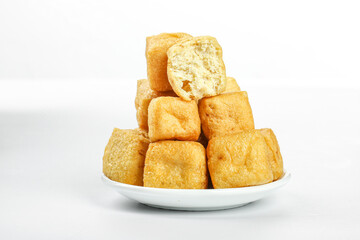 Deep-fried tofu cubes on white plate - delicious golden bean curd blocks ready to serve