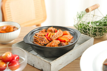 Roasted Goose and Potato Casserole in Farmhouse Kitchen with Fresh Herbs and Vegetables