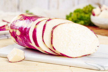 Fresh Purple Skinned White Yam Sliced on Wooden Cutting Board - Healthy Root Vegetable Ingredient