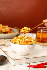 Traditional Yangzhou Golden Egg Fried Rice Chinese Cuisine Specialty in Bowl with Wooden Spoon