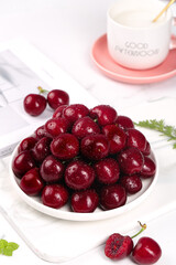 Fresh Red Cherries in White Bowl with Coffee Cup - Healthy Breakfast Concept