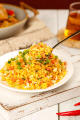 Yangzhou Fried Rice - Golden Chinese Gourmet Dish with Assorted Vegetables and Egg on Rustic Wooden Table