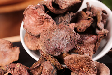 Dried Specialty Mushrooms Collection in Bowl - Gourmet Cooking Ingredients with Deep Red and Brown Colors