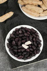 Yunnan Black Selenium-Enriched Peanuts and Dried Peanuts in Shells on Slate Background