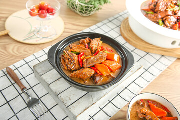 Braised Goose Stew with Potatoes and Vegetables in Traditional Asian Ceramic Pot