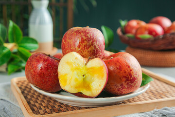 Fresh Daliangshan Red Apples Cut in Half on Wooden Tray Kitchen Display