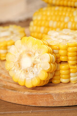 Fresh Sweet Corn Cobs with Golden Kernels on Wooden Cutting Board