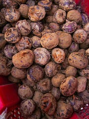 Fresh Farm Potatoes with Soil in Red Crates at Market Display