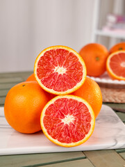 Fresh Blood Oranges with Red Flesh on Kitchen Cutting Board - Healthy Citrus Fruit