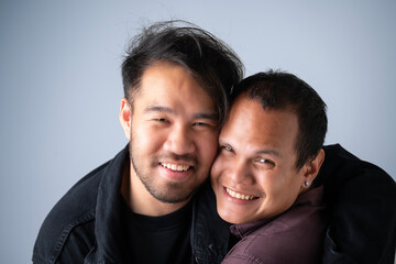 Obraz premium Smiling gay men looking at camera