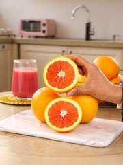 Fresh Blood Oranges with Red Flesh on Kitchen Counter - Healthy Citrus Fruit Preparation