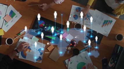 A top-down view of a diverse team engaged in a collaborative meeting, analyzing data through charts and visuals, highlighting the blend of teamwork and technology. Raster - Powered by Adobe