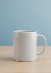 Fototapeta premium White ceramic mug with blue wall background