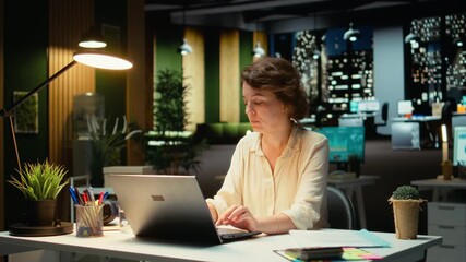 Female assistant engaging in a phone call after hours at the office, giving insight on financial data reports and other metrics for accounting. Chatting on a smartphone connection. Camera A. - Powered by Adobe