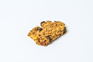 Delicious granola bar with almonds, oats, and dried cranberries, isolated on a white background. Close up view. clipping path. piece. cracked. broken.