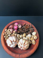 An arrangement of Indonesian spices that are a delicious and distinctive cooking spice, cooking spices arranged in a wooden mortar