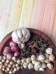 An arrangement of Indonesian spices that are a delicious and distinctive cooking spice, cooking spices arranged in a wooden mortar