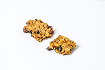 Delicious two granola bars with almonds, oats, and dried cranberries, isolated on a white background. Close up view. clipping path. piece. broken. cracked.