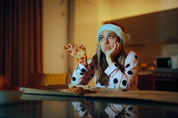 Sad Lonely Woman Eating Pizza at Home During Christmas Time. Unhappy depressed girl having fast...
