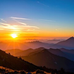 Mountain range view at sunset with orange glow horizon, soft shadows, blue sky, and golden rays. Nature's serene beauty