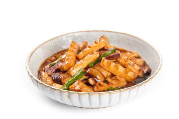 Stir-fried bamboo shoots with smoked bacon and spring vegetables in traditional ceramic bowl