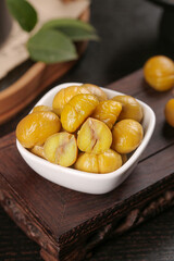 Roasted Chestnuts in White Bowl - Traditional Asian Snack Food on Rustic Wooden Background