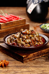 Spicy Stir-Fried Whelk with Red Chili Peppers - Traditional Asian Seafood Dish on Wooden Board