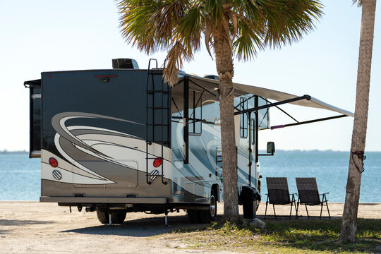 Fototapeta American motorhome parked on ocean shore in Florida. USA travel destination infrastructure.