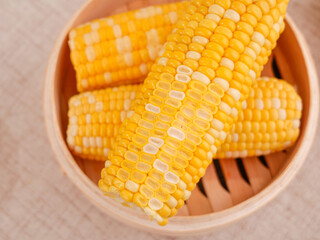 Fresh Sweet Corn Cobs in Bamboo Steamer Basket - Golden Yellow Kernels Ready to Eat
