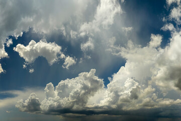 Bright landscape of blue sky with flying white clouds. Colorful summer skyscape