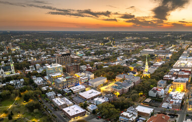 Historical American city architecture at night. Savannah, old city in Georgia state. Illuminated streets and buildings from above