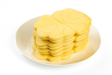 Golden Crackers with Ruffled Edges Stacked on White Plate - Traditional Snack Food Photography
