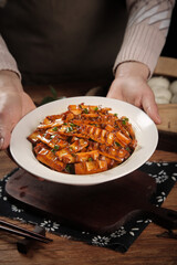 Stir-fried Pork with Bamboo Shoots and Mushrooms - Traditional Asian Cuisine in White Bowl