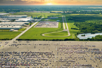 New cars for distribution at factory parking lot