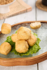 Golden Fried Tofu Cubes on Lettuce Leaves in Wooden Bowl - Healthy Asian Vegetarian Protein Food
