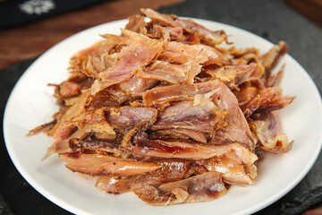 Traditional Dried Cured Meat Strips on White Plate - Baked Preserved Meat Snack Food