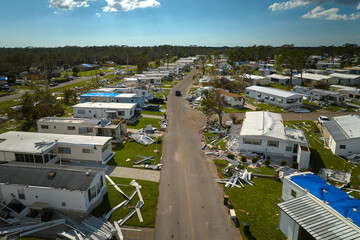 Severely damaged houses after hurricane Ian in Florida mobile home residential area. Consequences of natural disaster