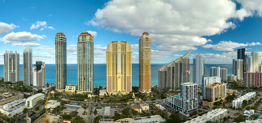 Sunny Isles Beach city with luxurious highrise hotels and condo buildings on Atlantic ocean shore. American tourism infrastructure in southern Florida