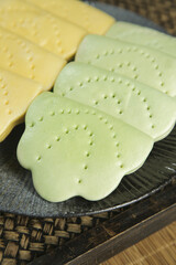 Traditional Chinese Lotus Leaf Shaped Steamed Cakes on Bamboo Steamer