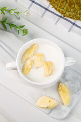 Frozen Durian Fruit Dessert in Bowl with Milk on Marble Background