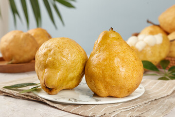 Fresh Golden Yellow Pears on Rustic Wooden Table with Natural Lighting