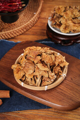 Dried Gourmet Mushrooms in Bamboo Basket - Authentic Cooking Ingredients on Wooden Board
