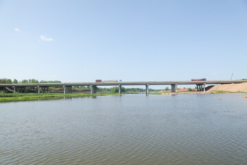 Obraz premium Concrete Bridge Over Calm River Waters with Natural Scenic Landscape View
