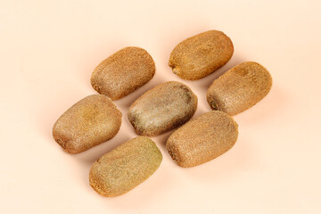 Heart-shaped arrangement of fresh kiwifruit from Guizhou China on neutral background