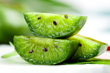 Fresh Mini Kiwi Fruit Slices with Water Droplets on Soft Green Background